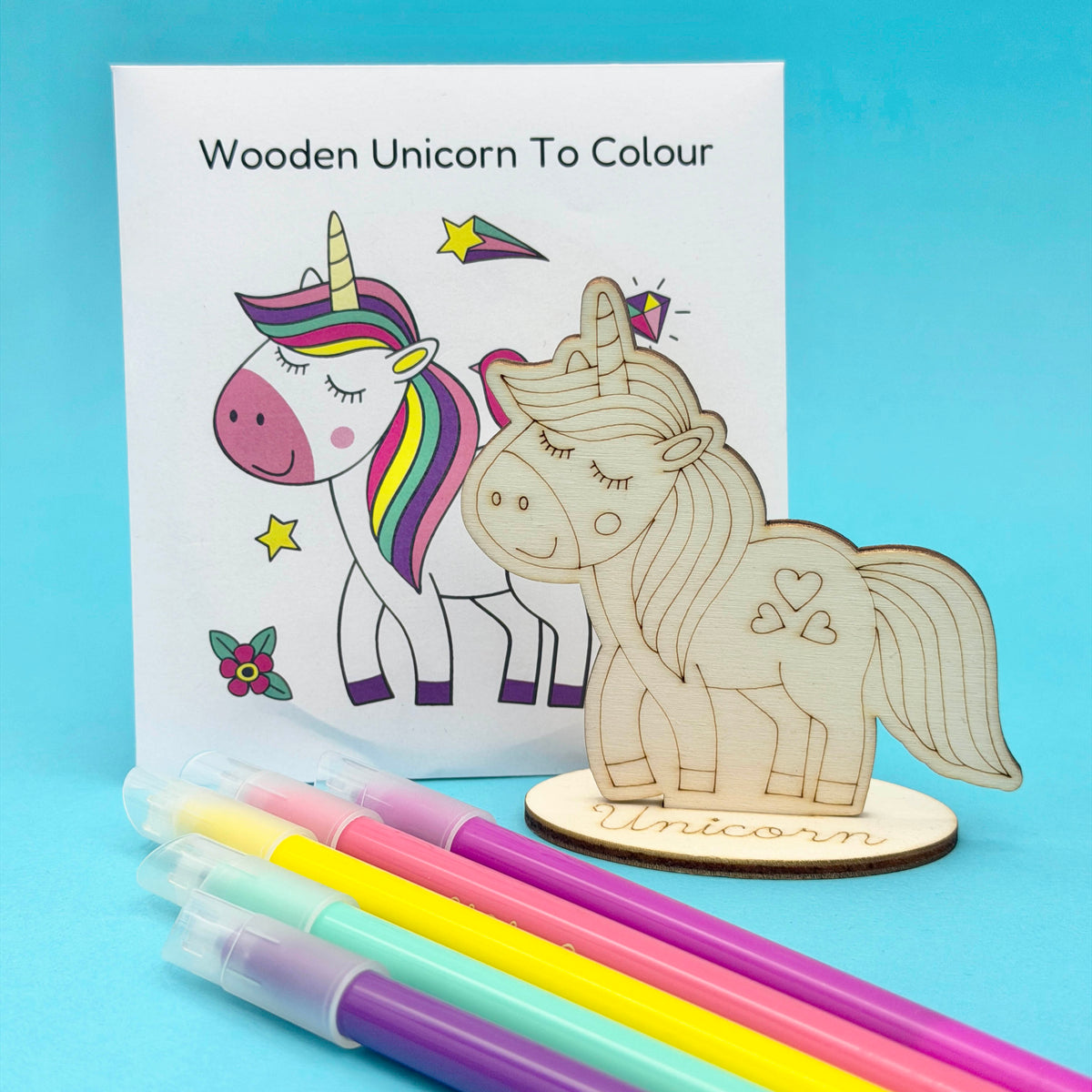 Wooden Unicorn to Colour; optional choice for a unicorn build-your-own party bag; supplied uncoloured, pens not included; coloured example shows decorating ideas.