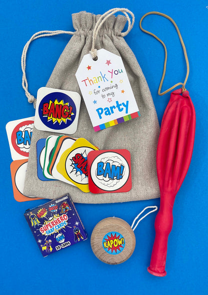 Superhero Cotton Party Bag, showing included contents and an optional thank-you tag; assorted colours and designs may vary.