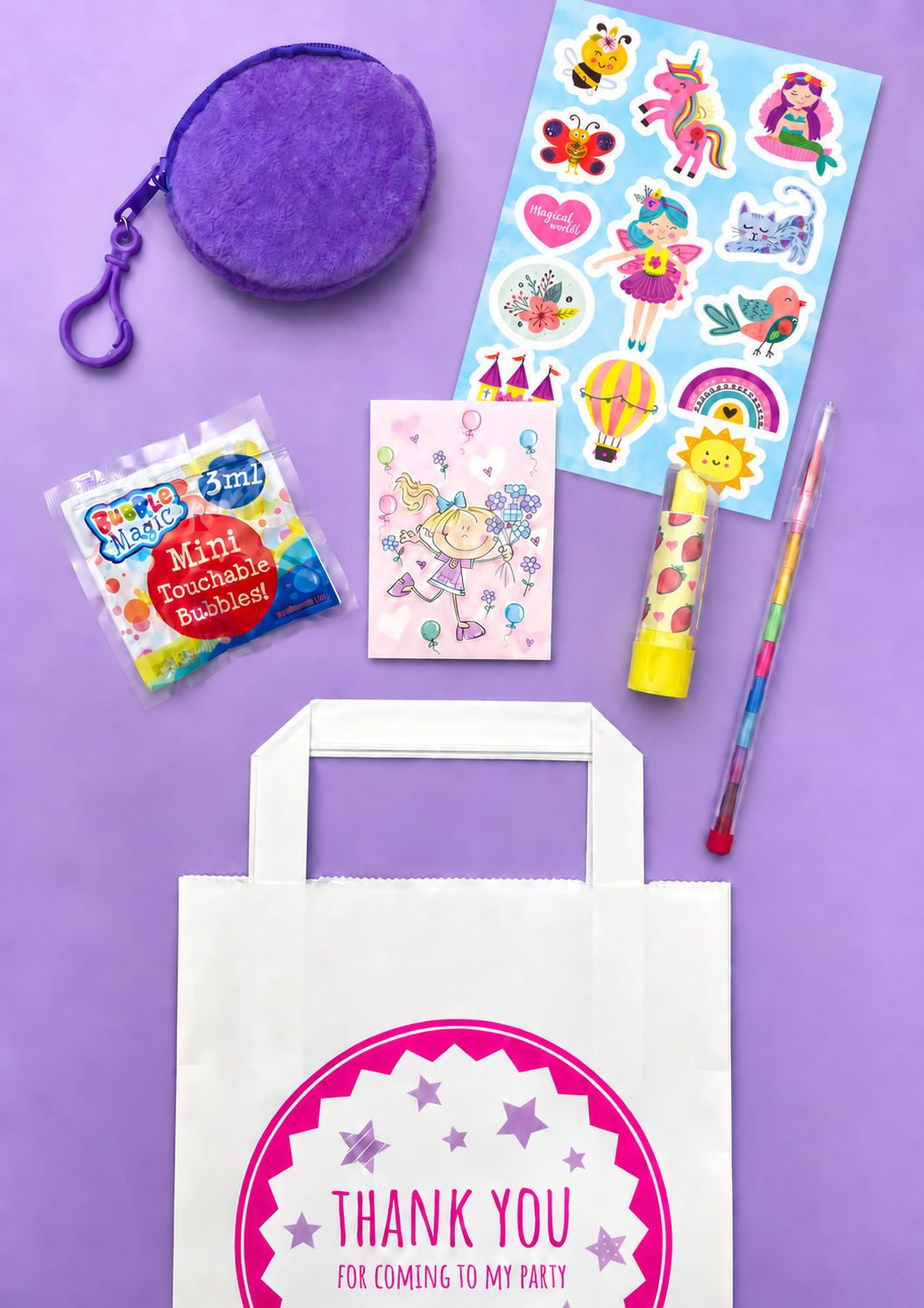 Girls bumper party bag for ages 3–8 with Magical World stickers, purse charm, bubbles, memo pad, lipstick eraser and rainbow pencil