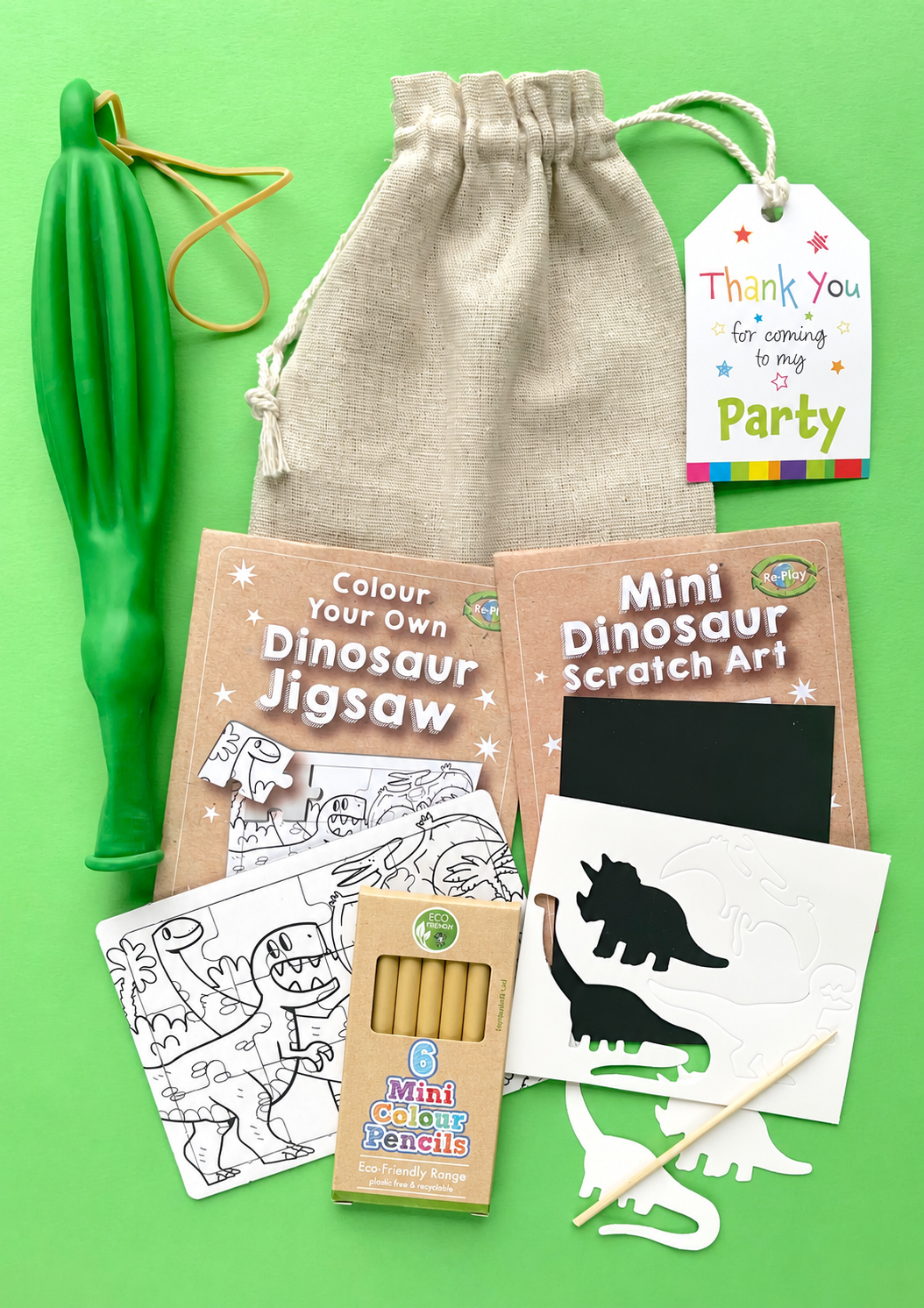 Stegosaurus eco cotton party bag with six mini colouring pencils, dinosaur colouring jigsaw, scratch art and green punch balloon